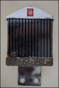 A Rolls Royce Chrome and enamel car badge with monogram for RREC to centre. Marked to the back for