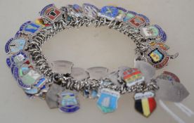 A vintage silver charm bracelet strung with numerous armorial place name fobs. Total weight 78g.
