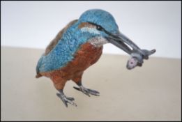 A cold painted bronze pincushion in the form of a