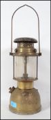A vintage early 20th century tilley lamp in gilded metal form with glass intact ( see