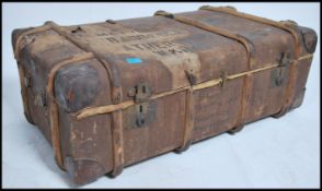 An early 20th century d-mob canvas and wooden bound steamer trunk chest with notation to centre