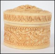 A 19th century intricately carved circular ivory t