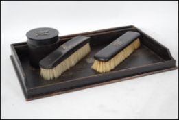 An Ebony and silver dressing table set, consisting