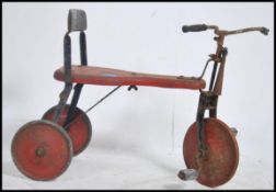 A mid century vintage childs trike - tricycle of metal form with remains of original paintwork