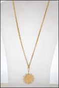 An Italian unoAerre gold 375 / 375 ball linked necklace chain with full sovereign 1978 ER II crown