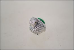 A silver pin cushion in the form of a bird. Marked