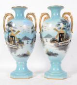 A pair of early 20th century Chinese influenced having blue grounds with twin gilded handles and