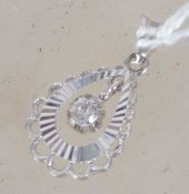 A white gold pendant with central floating stone (diamond?) stamped 750 to link for 18 ct gold.