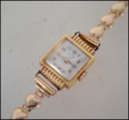 A vintage Marzo 17 Rubis 18ct gold cocktail watch with a 9ct gold pressed heart strap. Marked 18ct
