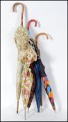 A collection of ladies parasols to include wooden handles, plastic, bamboo etc. All dating to the