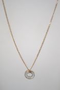A ladies 9ct gold necklace pendant and chain. The pendant of roundel form on a 52cms length chain