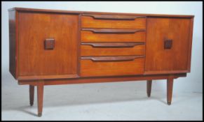 A 1970's teak wood Danish influenced sideboard by