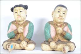A pair of large unusual 20th century Chinese carved wooden handpainted figures of a boy and girl,
