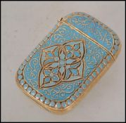 A brass vesta case with turquoise enamel decoratio