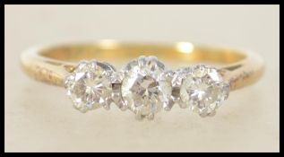 A vintage ladies 18ct gold, platinum and diamond 3 stone ring. The 3 diamonds being round cut approx