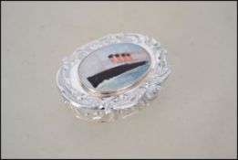 A silver pill box with Titanic image to lid. Marke