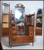 An Edwardian walnut drop centre bat wing dressing