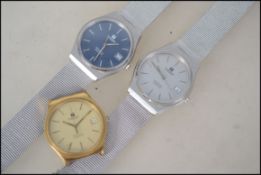 Three gents Tissot quartz watches.  One having golden bevel without strap, two having steel bevels