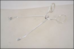 A pair of silver 800 marked DRGM sugar nips of sim