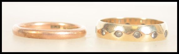 A marked 9ct gold wedding band along with a 9ct gold eternity ring. Approx. 5.6g