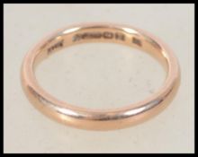 A hallmarked 9ct gold band ring bearing Birmingham