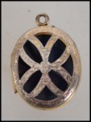 A 9ct gold locket pendant having pierced butterfly design to front and floral design to verso with