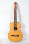 A full size  six string acoustic  Spanish Guitar by Resonata together with a three quarter sized six