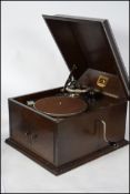 An early 20th century wooden cased HMV table top gramophone, lift up top fitted with His Masters