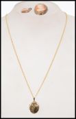 A 9ct gold curb link necklace chain having spring hoop clasp and a 9ct gold locket pendant alond