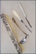 A silver hallmarked rococo clothes brush together