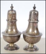 A pair of silver hallmarked salt and pepper pots b