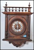 A Victorian oak cased country wall clock having enamelled pictorial numbers to the chapter ring with