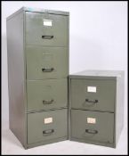 A vintage mid century metal filing cabinet having upright body with 4 drawers together with