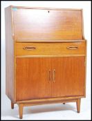 A 1970's retro teak wood bureau - office desk bein
