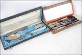 A cased Continental silver plated carving set cons