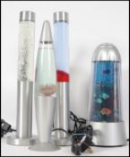 A group of retro 20th century vintage lava lamps two being cylindrical in shape, one being rocket