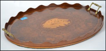 Edwardian tray of ovoid form, with two brass scrolled carry handles and satin wood inlaid conch