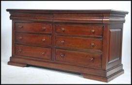 A good Victorian style mahogany double chest of drawers having a flared edge top over double bank of
