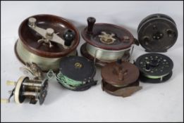 A collection of fishing reels to include bakelite