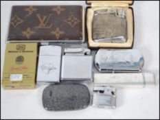 A collection of vintage 20th century smoking related items to include lighters etc please see