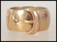A hallmarked 9ct gold and diamond buckle band ring. Hallmarked for London. Total diamonds 8pts.