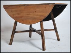 A retro Ercol drop leaf dining table being raised