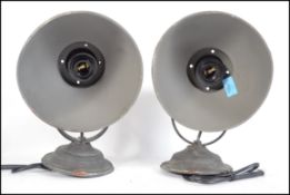 A pair of retro / vintage 20th century industrial wall lights. Each light having a circular wall
