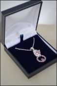 A 925 silver necklace strung with a leopard head pendant set with ruby and CZ.