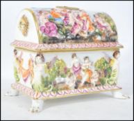 A large Capo Di Monte porcelain casket of large form being embellished with flowers and vine with