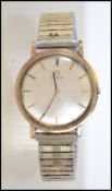 A vintage mid century 9ct gold Omega gentlemen's wristwatch having a silver dial with baton