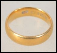 A hallmarked Victorian 22ct gold band ring bearing Birmingham assay marks. Rubbed makers marks