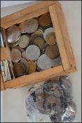 Two wooden boxes containing a one ruble Russian banknote; a multitude of different coins to