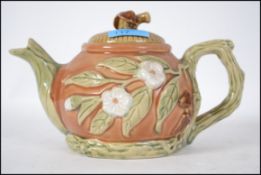 A 20th century Majolica teapot in the manner of George Jones having embellished glazed decoration