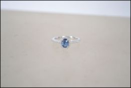 An 18ct white gold sapphire and diamond cluster ri